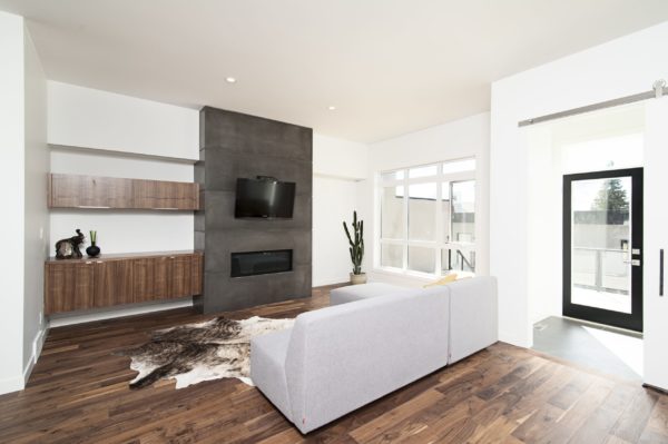 A beautiful interior shot of a modern house with white relaxing walls and furniture and technology